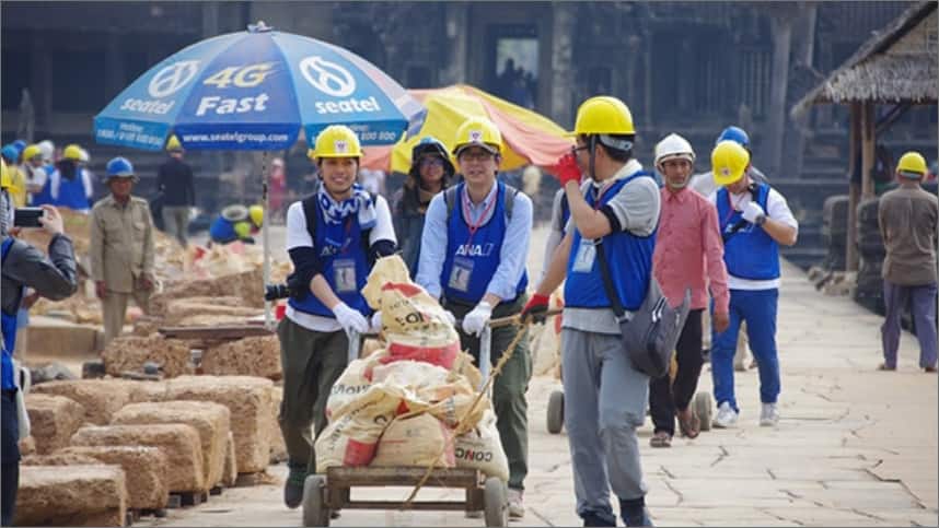 three ana employees pushing a cart at the Angkor wat