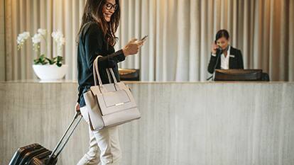 woman walking in front of hotel front desk